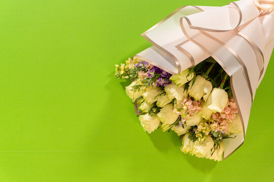 Wrapped Floral Gift on Green Background