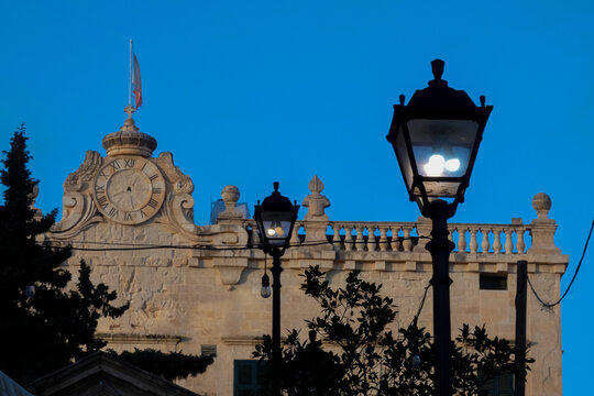 Malta street lamps silhouetted against blue hour sky