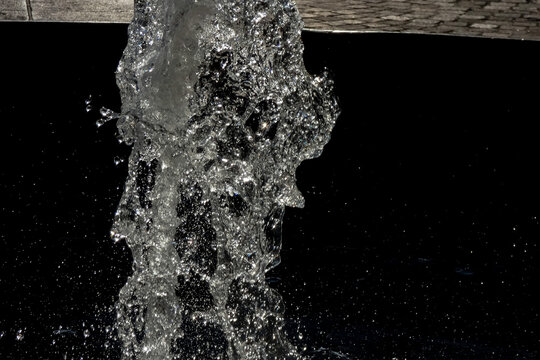 Sparkling water fountain splashing in urban setting