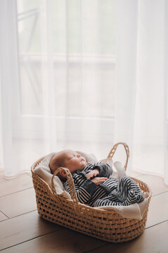 Newborn baby sleeping peacefully in a basket