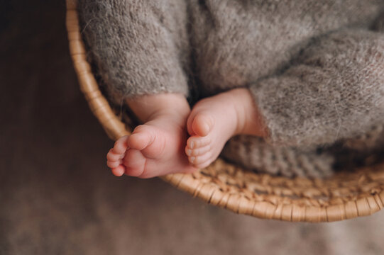 Tiny baby feet resting in a wicker basket