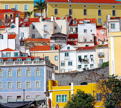 Colorful buildings stacked on a sunny Lisbon hill