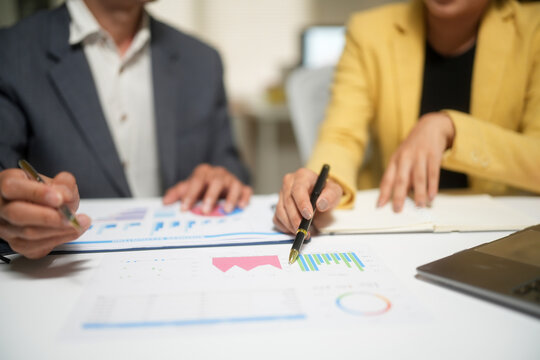 Business Team Analyzing Financial Charts in Meeting
