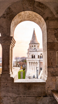 Fishermans Bastion tower seen through a stone archway