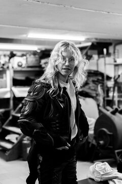Young blonde woman in protective gear in a workshop