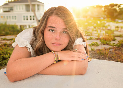 Young woman with freckles and blue eyes at sunset