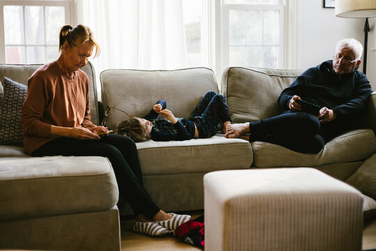 Grandparents and grandson relaxing on a sofa