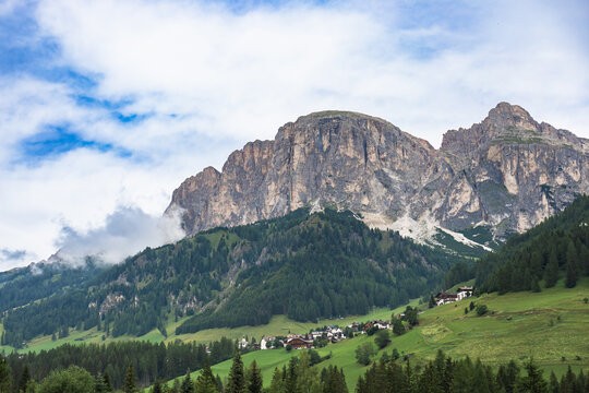 Small alpine village below majestic rocky mountains