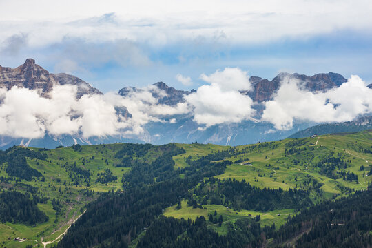 Dramatic cloudy peaks over rolling green valley