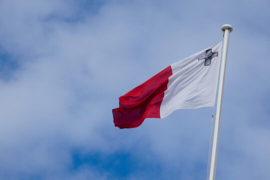 Maltese flag waving in the wind on a sunny day