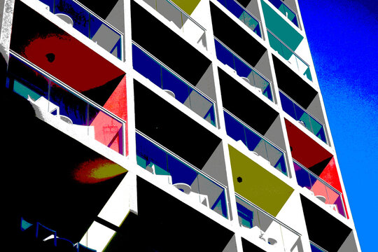 Colorful modern apartment building exterior with balconies and blue sky