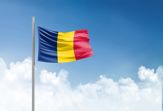 Chad flag waving in beautiful sky.