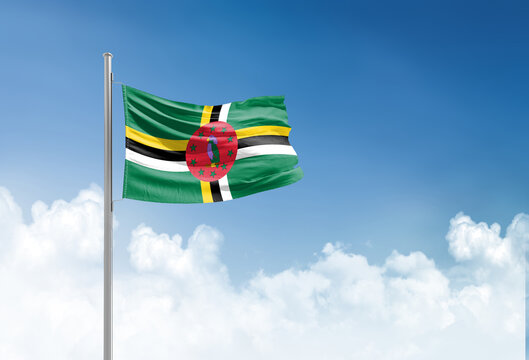 Dominica flag waving in beautiful sky.