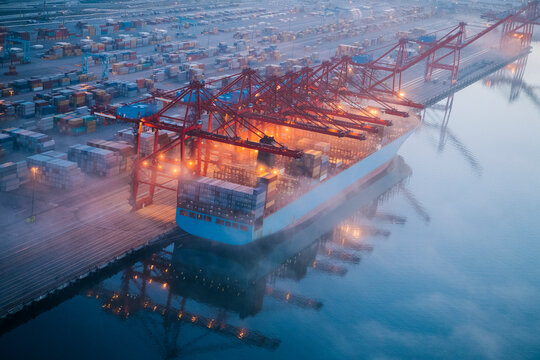 Large container ship unloading cargo at port terminal in Long Beach