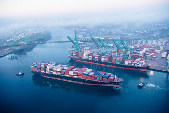 Aerial view of container ships at a busy port in a beach