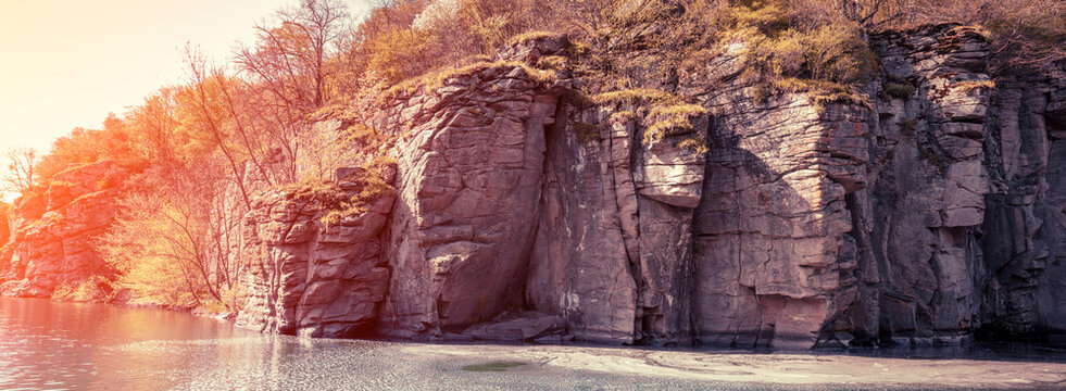 Rocky bank of a mountain river. View of the mountain river in early spring. Nature landscape
