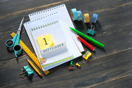 1 september date calendar concept. set of school stationery, notebooks on wooden table background. Back to school, education, Knowledge Day, creativity, artistic art concept. top view