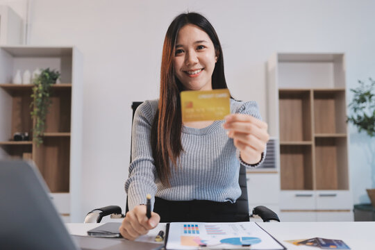 Young Asian business woman using smartphone and credit card for online shopping. Online Payment.