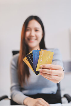 Young Asian business woman using smartphone and credit card for online shopping. Online Payment.