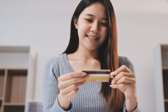 Young Asian business woman using smartphone and credit card for online shopping. Online Payment.