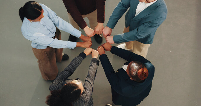 Business, people and meeting with fist bump for collaboration, unity or team solidarity. Top view, diversity or group of employees with hands together in huddle for cohesion, inclusion or mission