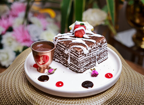 Layered Chocolate Spartak Honey Cake with Strawberry and Warm Chocolate Sauce