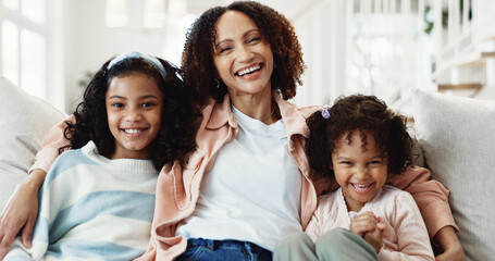 Obraz premium Smile, mother and kids in home with love, laugh and hug for connection with portrait of daughter. Happy girls, sister and parent on sofa with family embrace for support, care and relax together