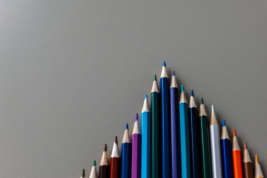 Colorful Pencils Form an Upward Arrow Symbolizing Leadership and Competition