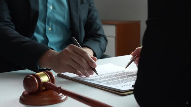 Lawyer advising client on legal contract signing
