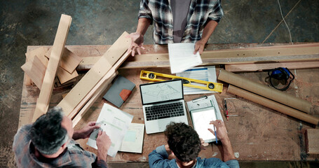 Naklejka premium People, carpenter and laptop at workshop with document, stock and timber price for production. Above, team and tech at warehouse for carpentry, quotation and mockup space for manufacturing furniture