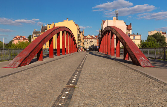 Red Steel Arch Bridge in Poznan, Poland on a Sunny Day