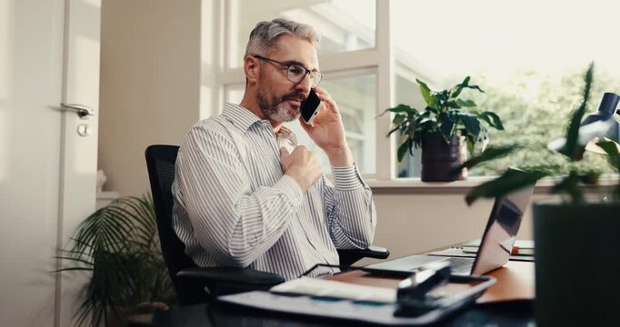 Home office, man and laptop with phone call for remote work, executive update or CAC cost review. WFH, mature growth lead and chat on tech for marketing ROI, competitor reporting or campaign feedback