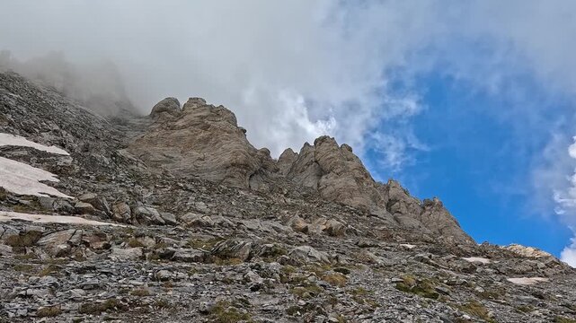 Snowfields and Rocky Peaks Emerging Through Clouds on Mount Olympus, Greece