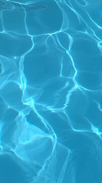 Water surface reflects light in a swimming pool during a sunny day