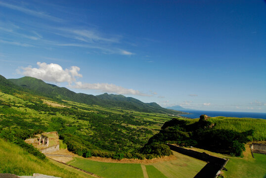 St Kitts and Nevis, Brimstone Hill, Brimstone Hill Fort with mountain and sea in the background against cloudy sky