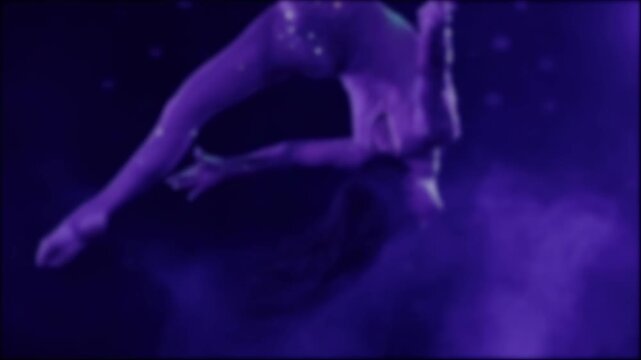 Female acrobat and gymnast performs aerial silks routine on dark stage under vibrant purple and pink spotlights, showing incredible flexibility and strength during captivating show, slow mo, blurry