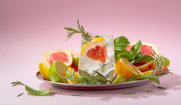 Refreshing summer cocktail with ice, citrus, rosemary and mint.