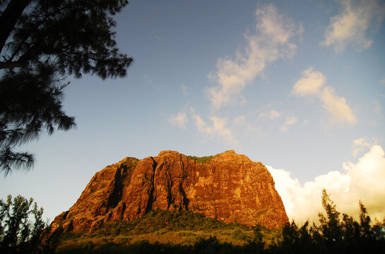 Mauritius, Le Morne, photo of a rocky huge cliff with trees against sky at dusk