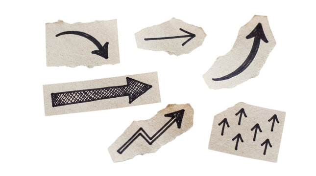Set of hand drawn arrows on torn paper scraps isolated on a black background for design elements