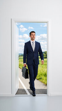 A man in a dark blue suit walks through an open door into a green landscape under a blue sky, carrying a briefcase, symbolizing career opportunity.