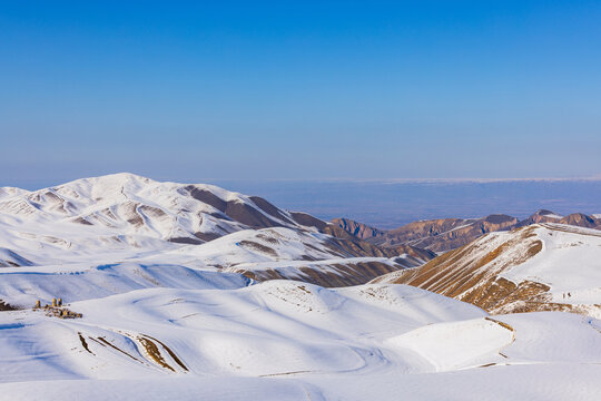 Vast Snowy Mountain Landscape with Ancient Structures