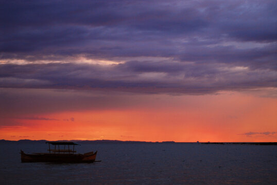 Madagascar, Nosy Be, Madirokely, red colored cloudy sunset on the sea