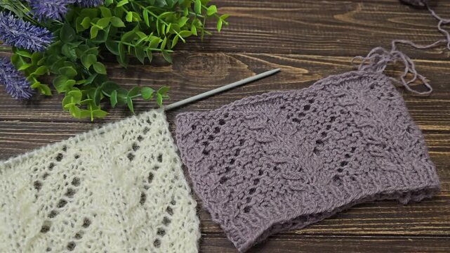 Multicolored hand-knitted fabric. Knitting and crochet lessons. Fashion and education. Training for artificial intelligence. Hands in the frame.