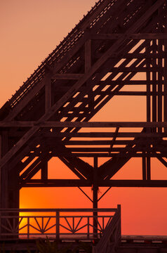 Madagascar, Morondava, Kimoni, sunset on wooden abandonned structure by the beach
