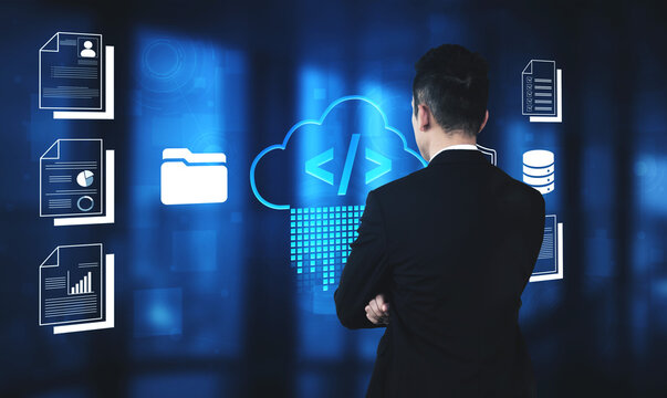 Professional Man Analyzing Digital Data and Cloud Technology with Visual Representations of Files and Coding Symbols in Modern Office Environment Fluxor.