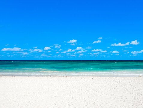 White tropical beach in Maldives with few palm trees and blue lagoon