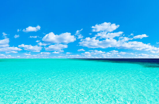 Beach and beautiful tropical sea. Blue sky and white clouds.