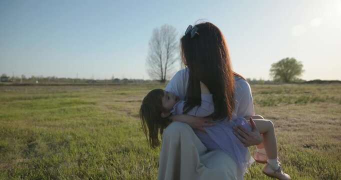 Young mother with child daughter spend time playing enjoying nature. 4K 10-bit