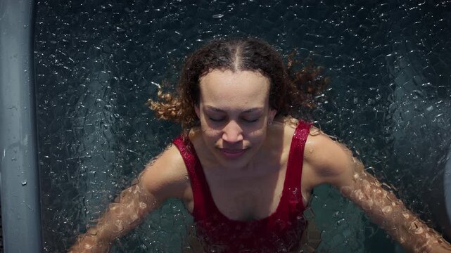 Water surrounds the woman in a cold plunge ice bath for outdoor recovery
