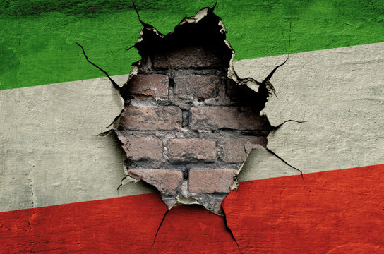 flag of the Islamic Republic of Iran are painted on an old wall with a cracked